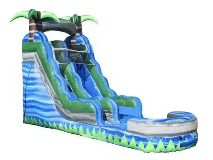Tropical-themed inflatable water slide with palm trees, blue wave design, and splash pool. Perfect for summer fun. Buy online in Canada today!