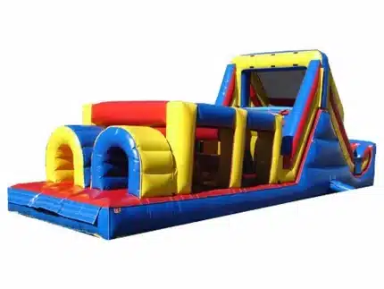 Large inflatable obstacle course with tunnels, climbing wall, and vibrant red, yellow, and blue design. Perfect for events. Buy online in Canada!