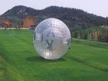 Large inflatable Zorb ball for rolling fun on grass or slopes. Perfect for outdoor events and activities. Buy online in Canada today!