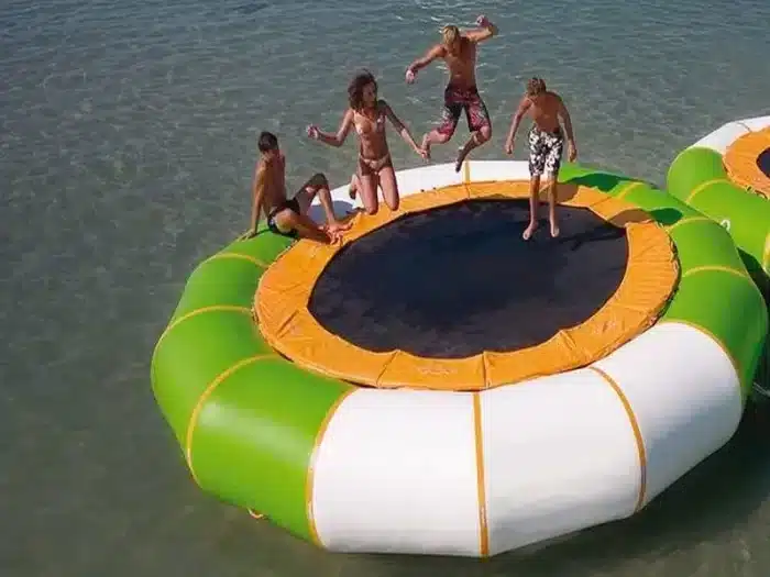 Inflatable water trampoline with green and white design, perfect for lakes and summer fun. Great for group activities. Buy online in Canada today!