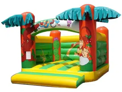 Tropical-themed bouncy castle with palm trees and jungle animal graphics, perfect for outdoor kids' parties. Buy online in Canada for fun and adventure!