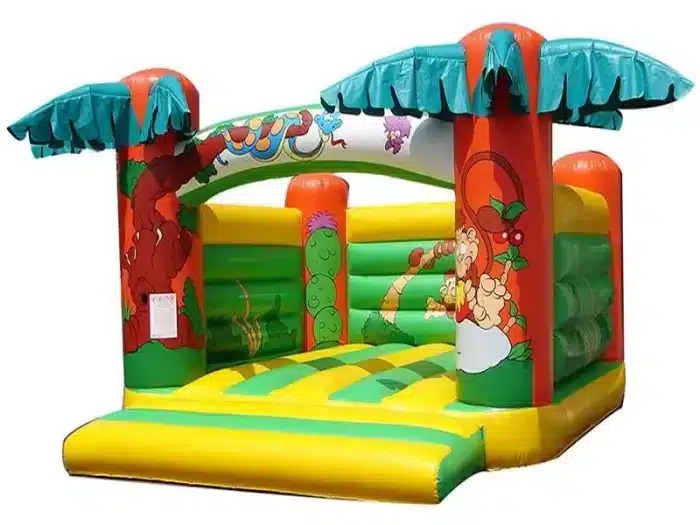 Tropical-themed bouncy castle with palm trees and jungle animal graphics, perfect for outdoor kids' parties. Buy online in Canada for fun and adventure!