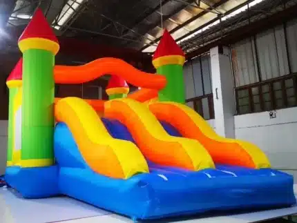 Bright inflatable bouncy castle with dual slides and vibrant castle design. Perfect for kids' events. Buy high-quality bouncers online in Canada!